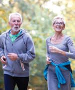 Senior man and woman jogging and following a suggested Mediterranean diet