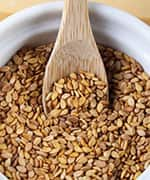 Whole grains in bowl with wooden spoon load a diet of omega-6 fats