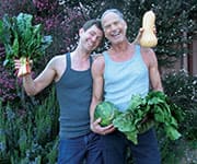 John and friend holding fresh garden vegetables that take several supplements daily