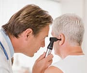 Physician examining patient’s ears for evidence of sensorineural hearing loss