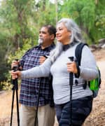 Overweight couple hiking on trail that are living in a higher fast-food concentrated neighborhood