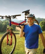 Man carrying mountain bike dealing with neuropathic pain from diabetes