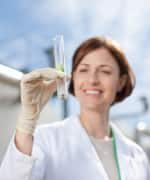 Woman researcher holding vial with sample of ashwagandha for restorative sleep study