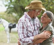 Senior couple hugging with husband having age-related reduced testosterone levels