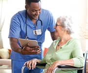 Nurse speaking with patient in wheelchair on her stress levels