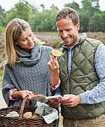 Couple examining foraged mushroom that can support telomeres