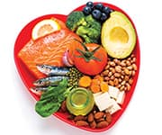 Heart-shaped plate with foods rich in omega-3s that can lower triglycerides