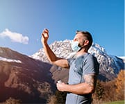 Man holding vitamin d supplement up to sun that can be used to boost immunity