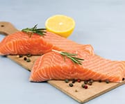 Two uncooked salmon fillets that when added to diet can benefit brain and heart health