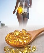 Wooden spoon stacked with vitamin D supplements that fill deficiency gap