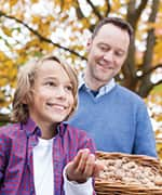 Father and child picking walnuts that are packed with healthy fats and vitamins