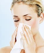 Woman blowing nose with lowered beta glucans and immune responses