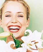 Woman laughing around flowers with improved immune system