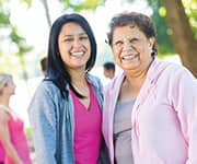 Woman wearing pink smiling with pain relief needs