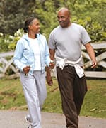 Man and woman walking for better physical capacity heart health