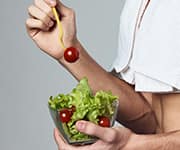 Man eating salad with cherry tomatoes for boosting nutrient intake