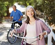 Wife and husband riding bikes for improved longevity