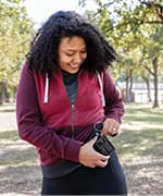 Woman at park taking blood glucose levels