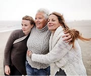 Three women on cold beach to absorb vitamin D