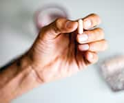 Man holding up capsule of bioavailable resveratrol