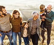 Multigenerational family taking walk through field