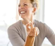 Laughing woman taking effcient vitamin C supplement