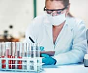 Researcher taking notes on levels of coq10 in blood samples