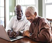 Husband and wife using laptop for brain-aging