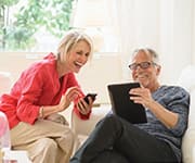 Wife and husband using tablet and phone