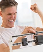 Man celebrating weight management by increased resting energy expenditure