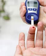 Man doing a blood test strip for glucose control