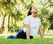 Woman practicing yoga in a park