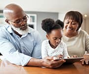 Grandparents and child using a tablet with increased dopamine levels