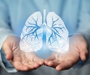 Man holding up hologram of lungs affected by COPD