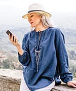 Woman reading about a blend of three plant extracts for reducing urinary