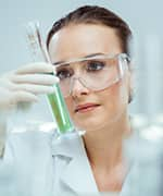 Lab researcher holding test tube filled with specialized pro-resolving mediators