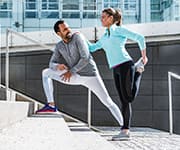 Husband and wife stretching before doing a cardio workout