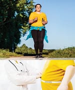 Woman jogging outside and then measuring waist